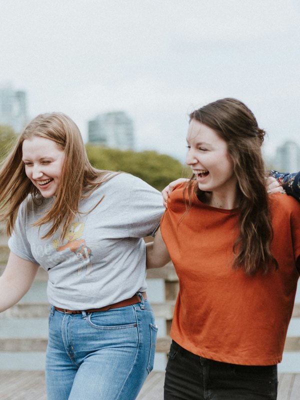 Three friends walking on a wooden boardwalk